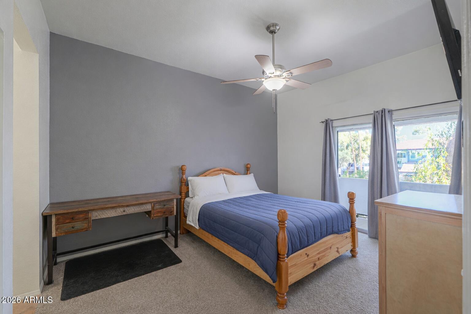 1331 West Baseline Road, Unit 225 Mesa, AZ 85202 - Photo 28 of 47 a bedroom with a bed and a ceiling fan