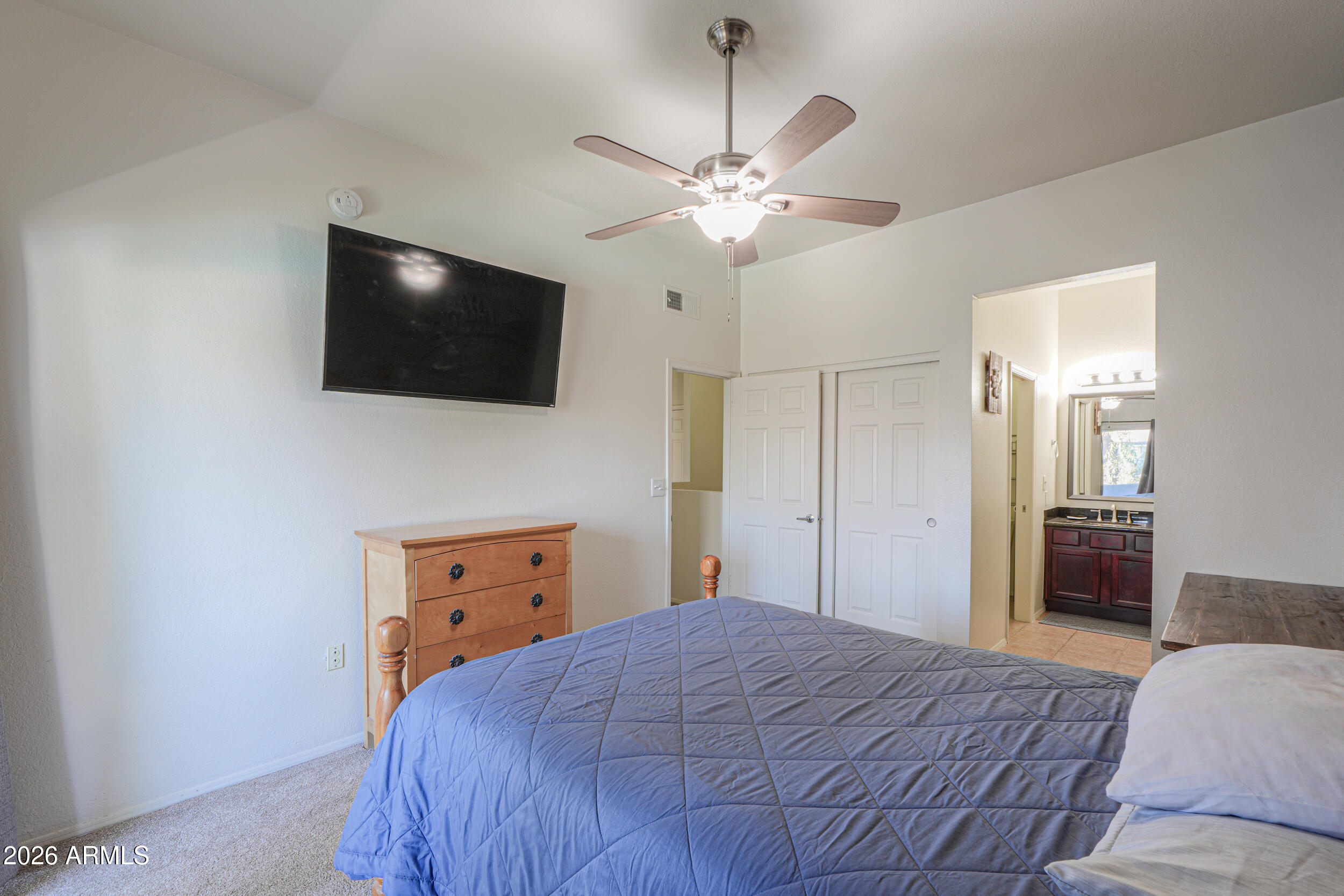 1331 West Baseline Road, Unit 225 Mesa, AZ 85202 - Photo 29 of 47 a bedroom with a bed and a flat screen tv
