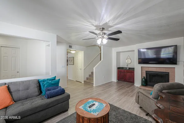 a living room with furniture a fireplace and a flat screen tv
