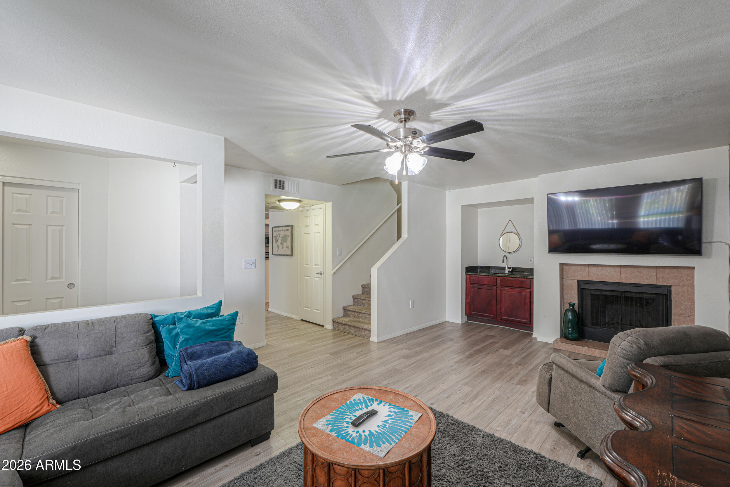 1331 West Baseline Road, Unit 225 Mesa, AZ 85202 - Photo 3 of 47 a living room with furniture a fireplace and a flat screen tv