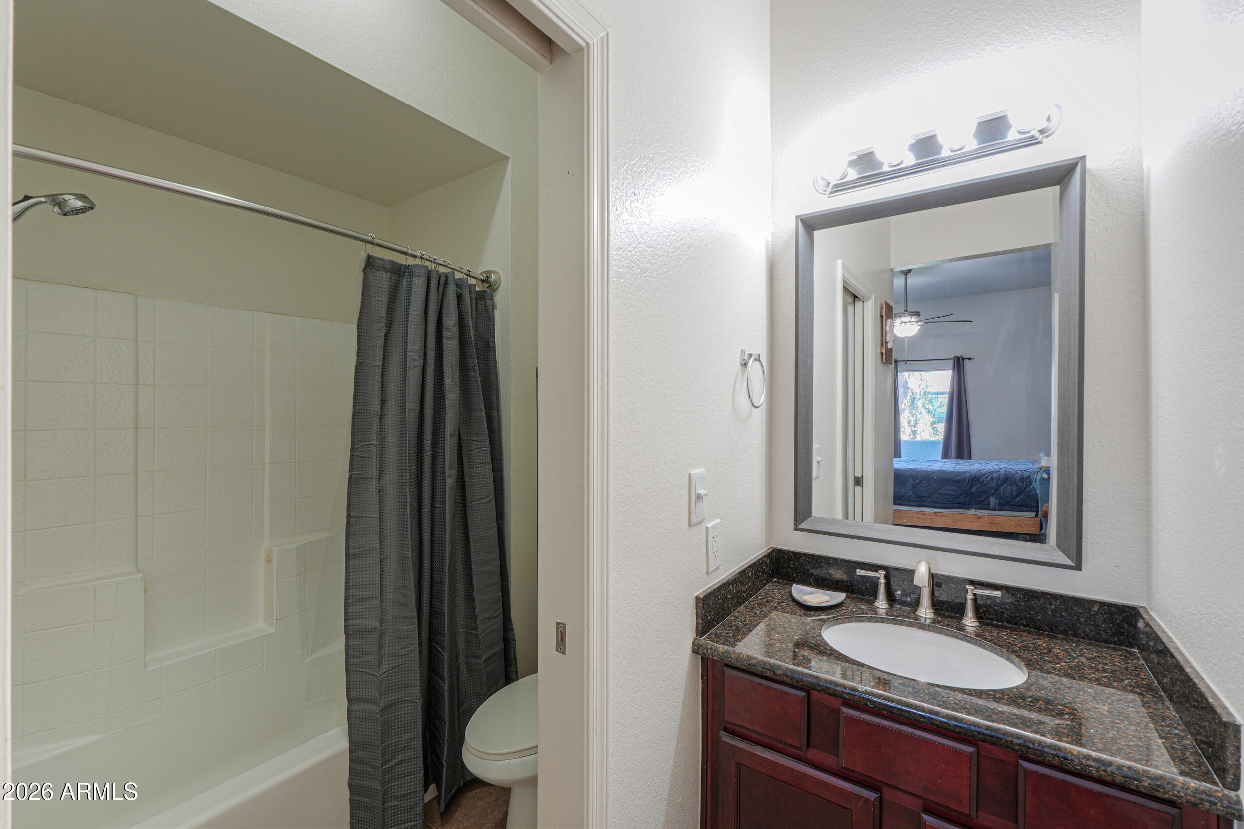 1331 West Baseline Road, Unit 225 Mesa, AZ 85202 - Photo 31 of 47 a bathroom with a granite countertop sink mirror and a bathtub