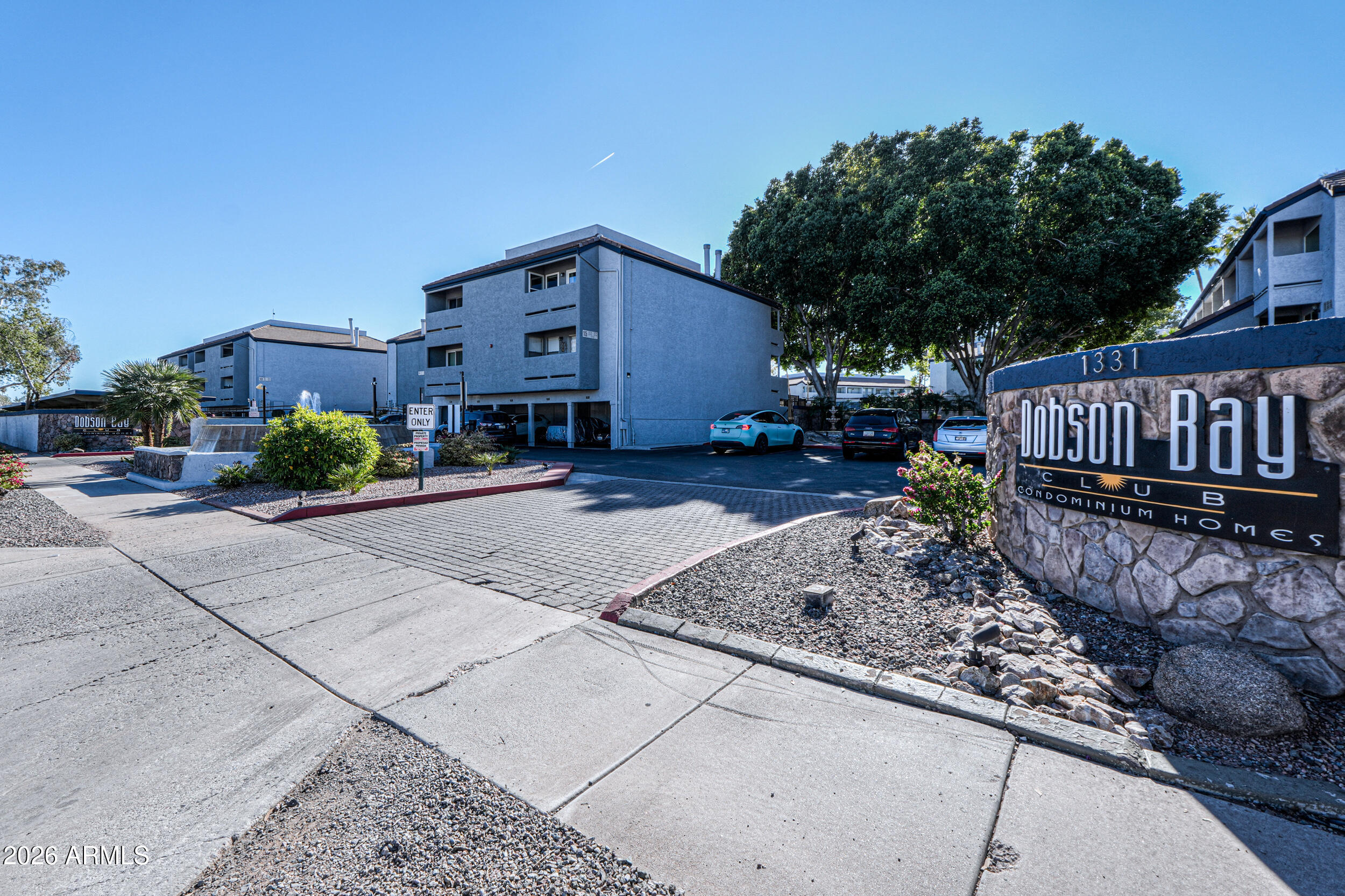 1331 West Baseline Road, Unit 225 Mesa, AZ 85202 - Photo 34 of 47 a view of a house with wooden fence next to a road