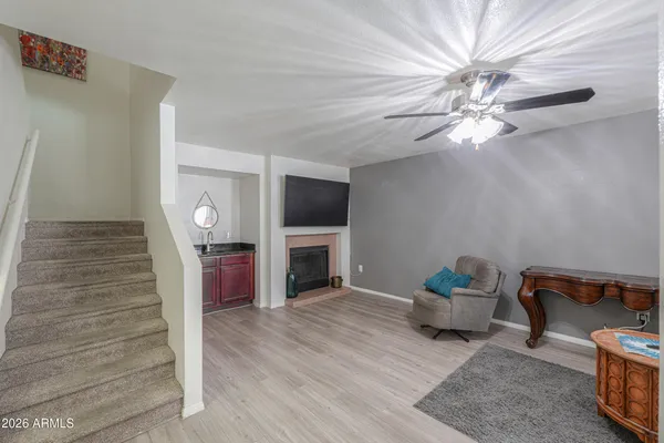 a living room with furniture a fireplace and a flat screen tv