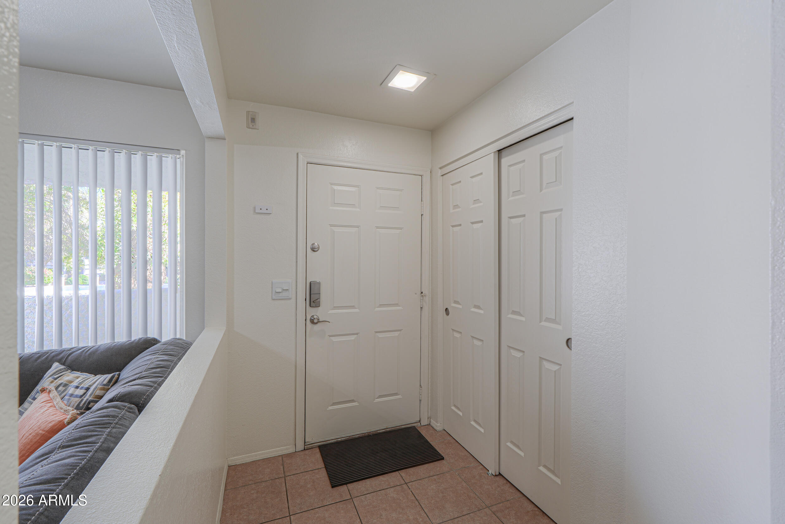 1331 West Baseline Road, Unit 225 Mesa, AZ 85202 - Photo 6 of 47 a view of a hallway with a couch