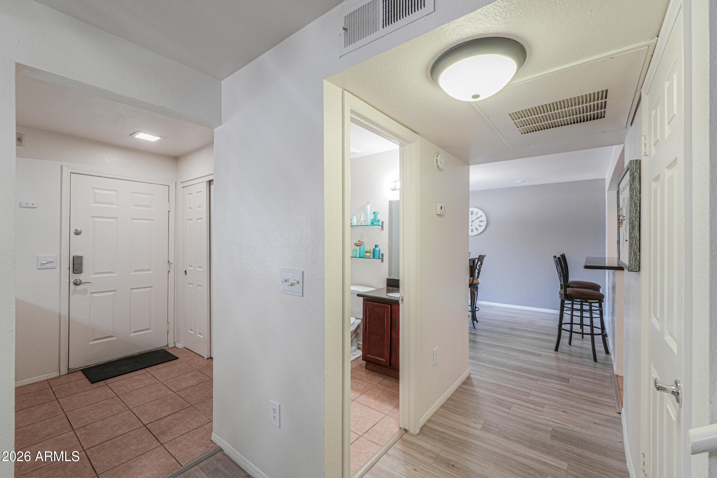 1331 West Baseline Road, Unit 225 Mesa, AZ 85202 - Photo 8 of 47 a view of a hallway and dining room