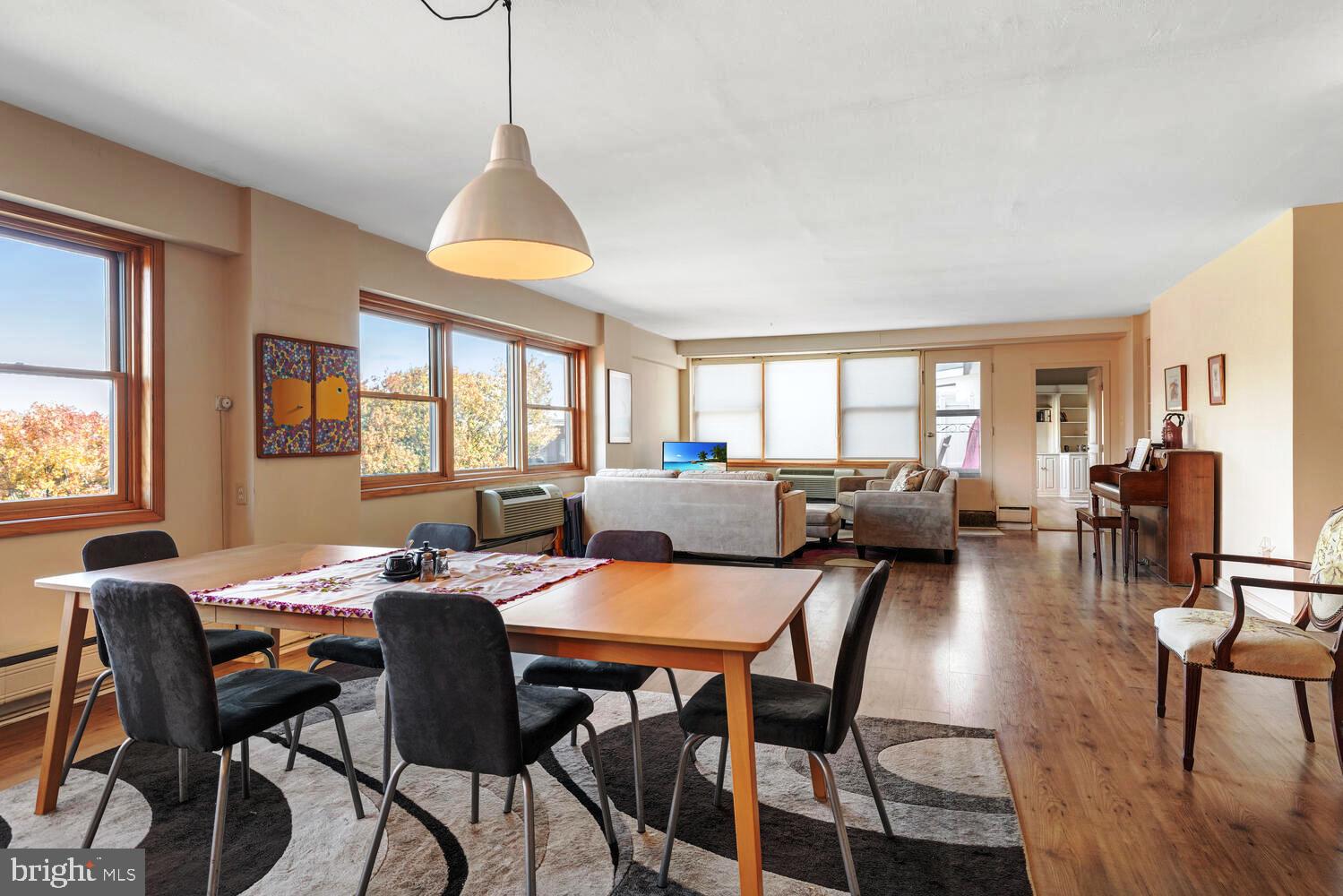 7900 Old York Road, Unit 907A Elkins Park, PA 19027 - Photo 12 of 36 a dining room with furniture a chandelier and wooden floor