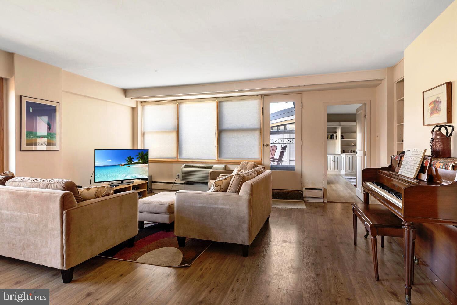 7900 Old York Road, Unit 907A Elkins Park, PA 19027 - Photo 14 of 36 a living room with furniture and a flat screen tv