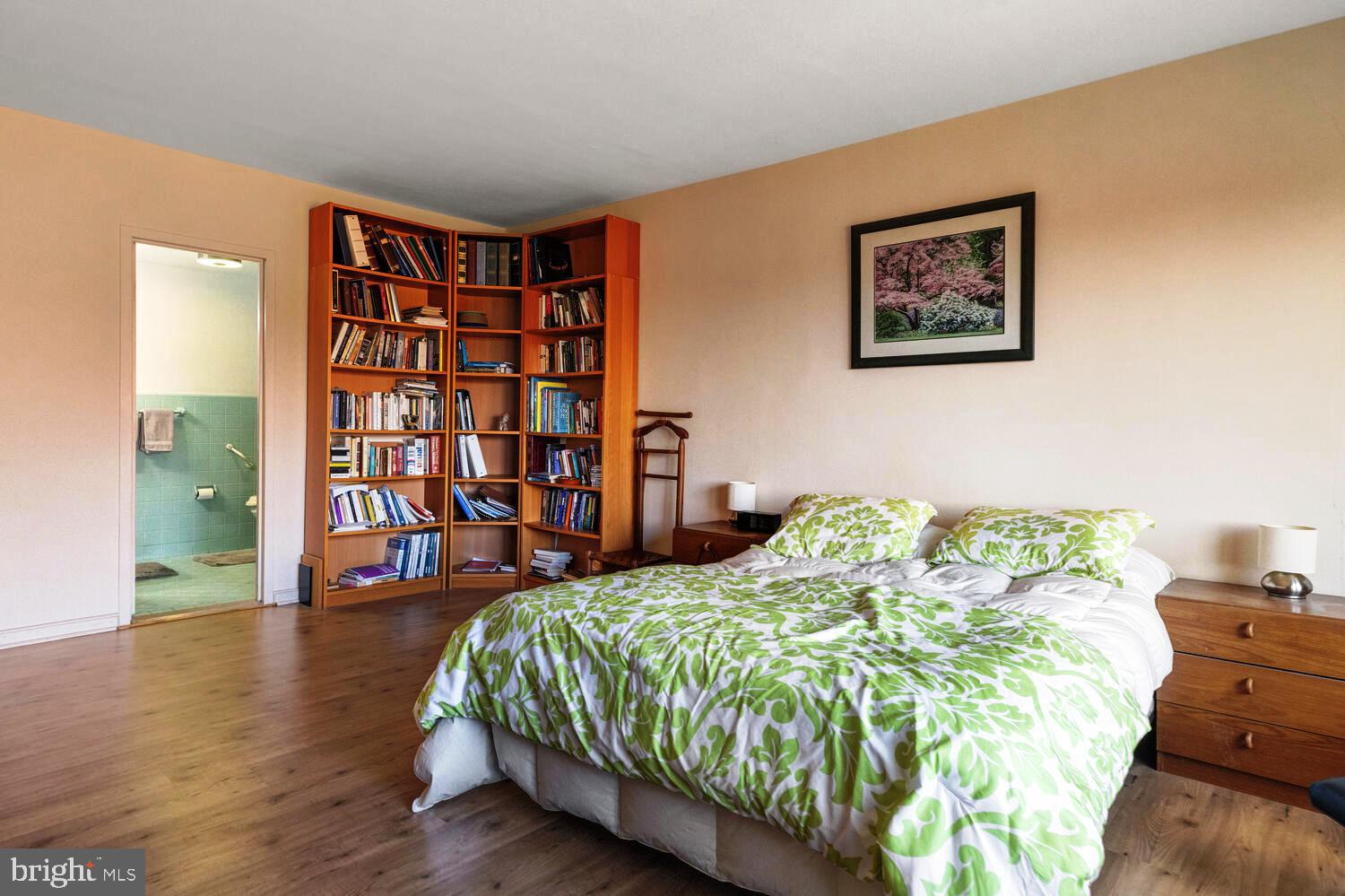 7900 Old York Road, Unit 907A Elkins Park, PA 19027 - Photo 25 of 36 a bed sitting in a bedroom next to a book shelf