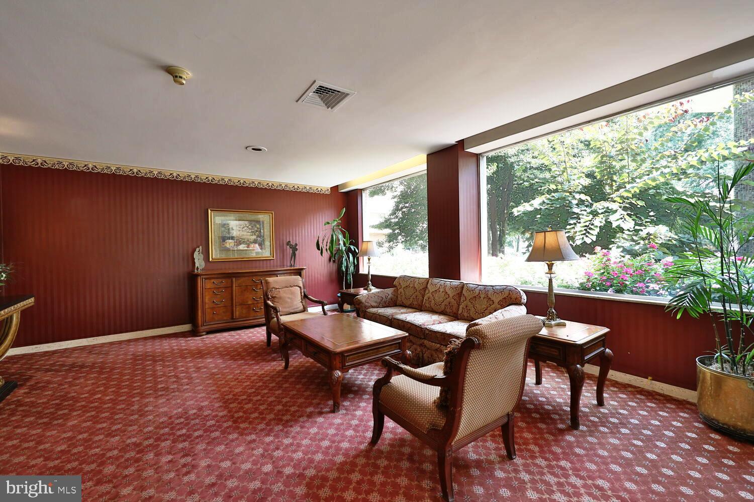 7900 Old York Road, Unit 907A Elkins Park, PA 19027 - Photo 3 of 36 a living room with furniture a rug and a window