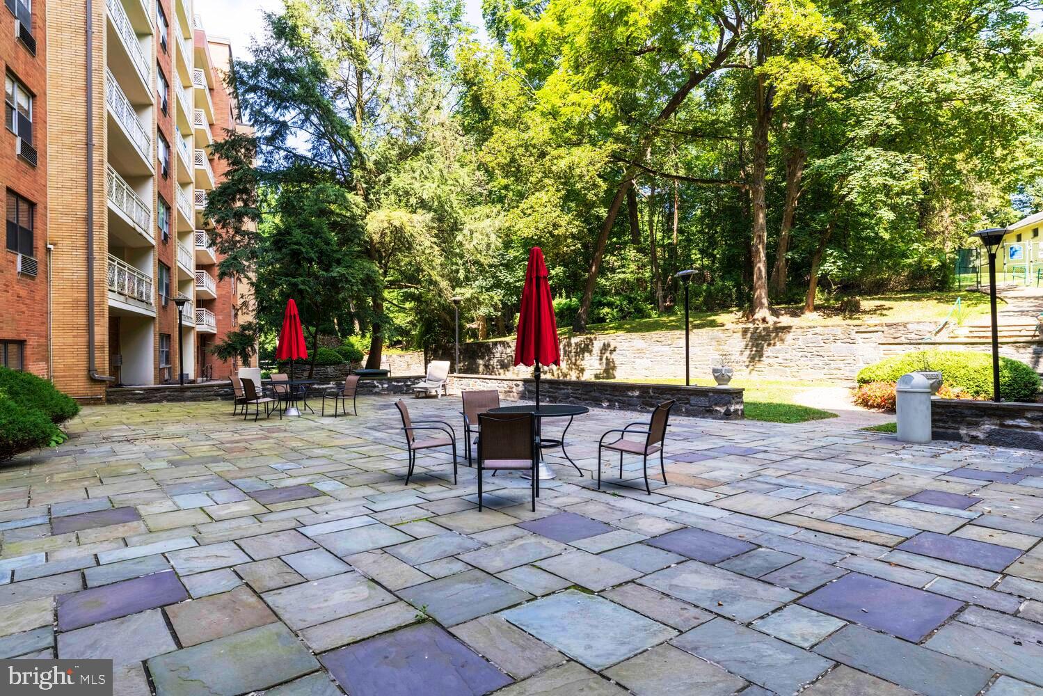 7900 Old York Road, Unit 907A Elkins Park, PA 19027 - Photo 33 of 36 a view of a patio with table and chairs and potted plants
