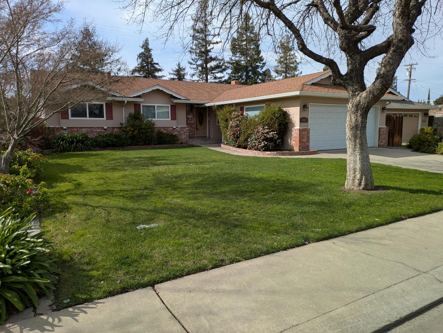 3417 John Lee Lane Modesto, CA 95350 - Photo 1 of 1 a front view of a house with a garden