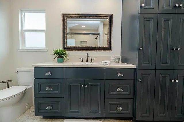 a bathroom with a sink vanity and a mirror