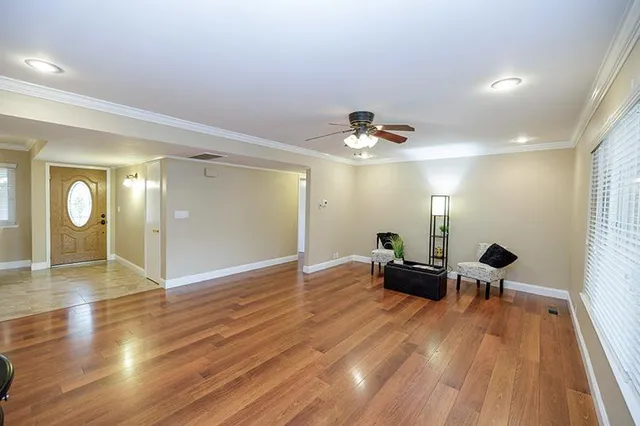 a view of a room with wooden floor and furniture