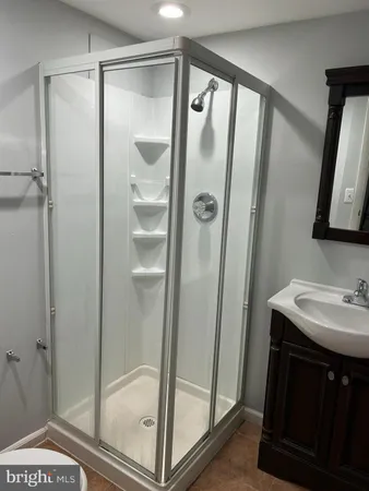a bathroom with a shower and a sink