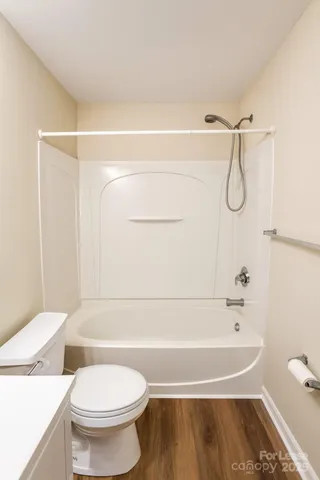 a bathroom with a toilet and a bathtub