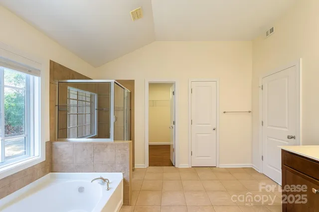 a bathroom with a tub shower and sink