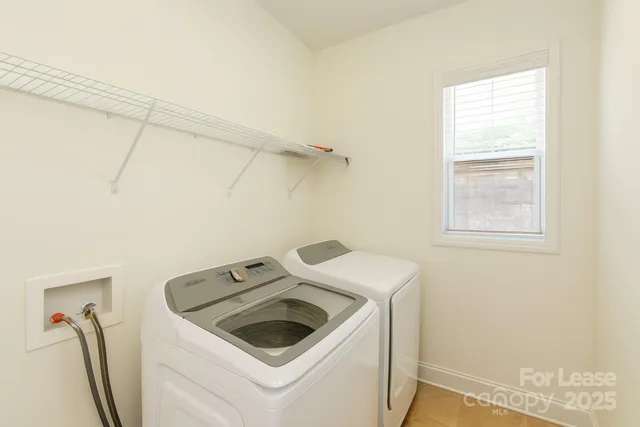 a view of a storage and utility room with washer and dryer