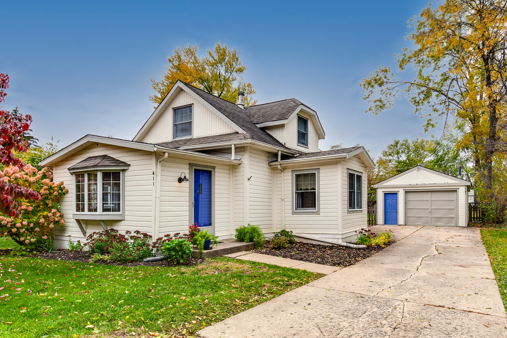a front view of a house with garden
