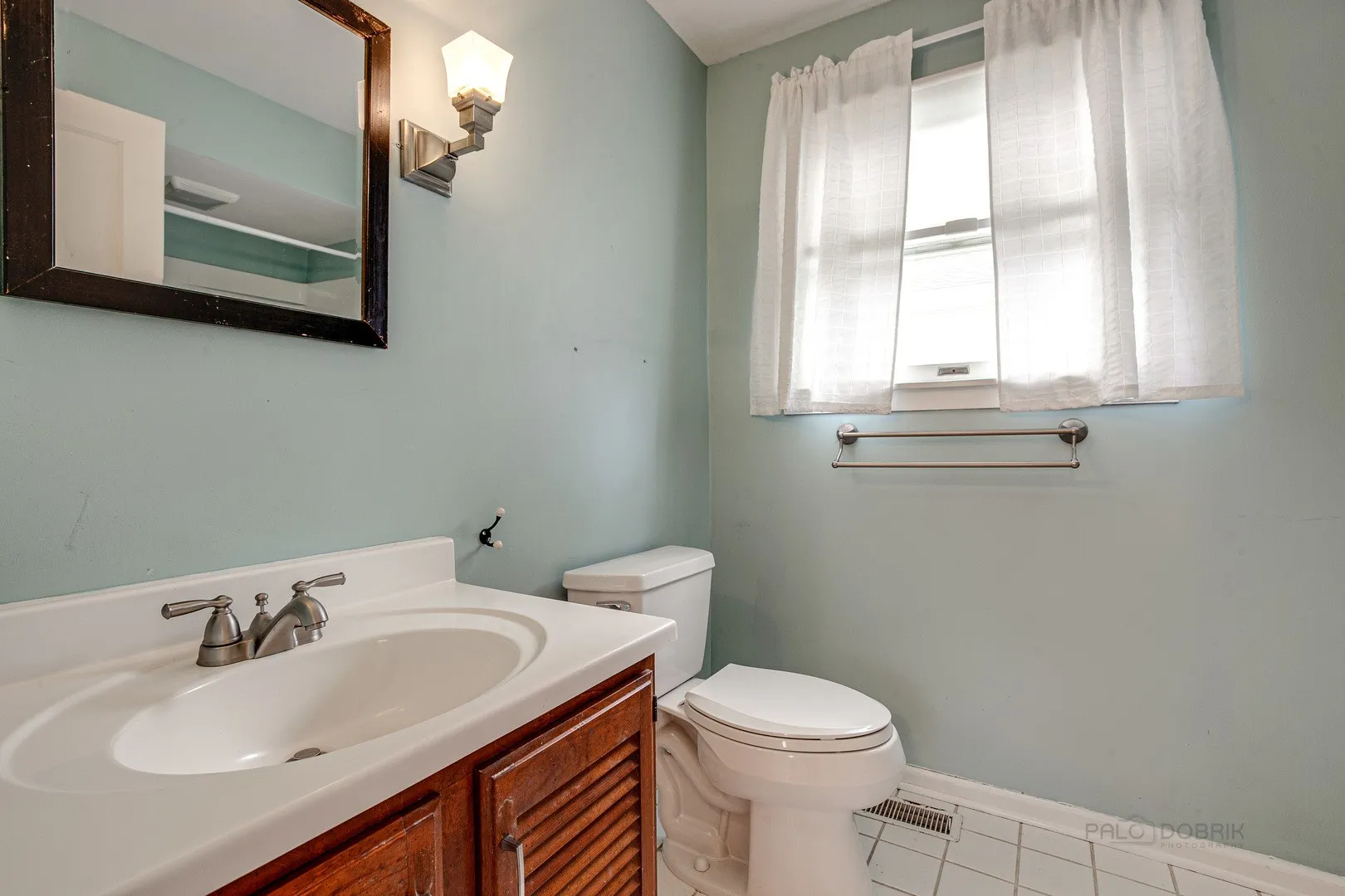 411 Foster Road Wauconda, IL 60084 - Photo 12 of 23 a bathroom with a sink a toilet and a mirror