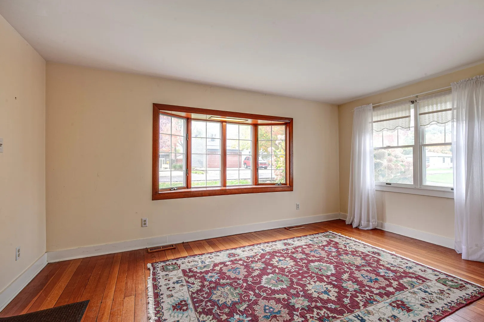 411 Foster Road Wauconda, IL 60084 - Photo 2 of 23 a view of an empty room with a window and wooden floor