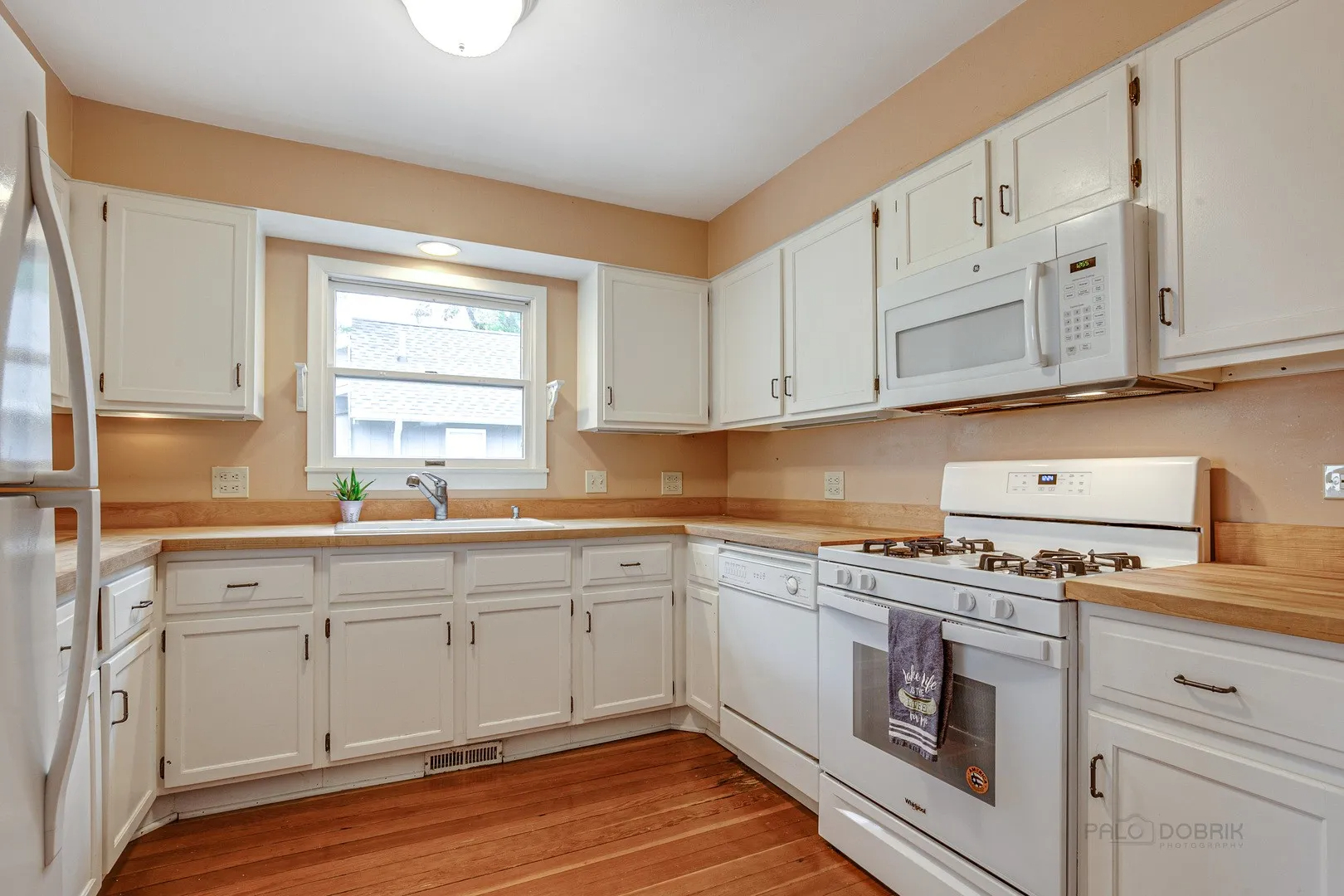 411 Foster Road Wauconda, IL 60084 - Photo 6 of 23 a kitchen with cabinets appliances a sink and a window