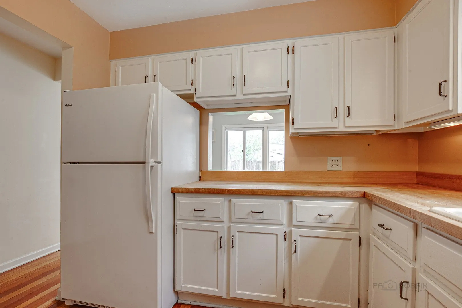 411 Foster Road Wauconda, IL 60084 - Photo 7 of 23 a kitchen with white cabinets and white appliances
