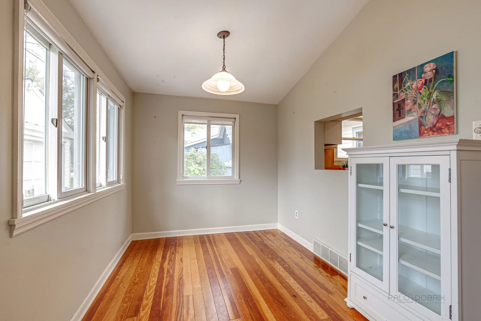 411 Foster Road Wauconda, IL 60084 - Photo 9 of 23 a view of a room with wooden floor chandelier and windows