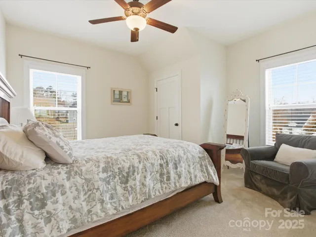 a bedroom with a bed couch and window