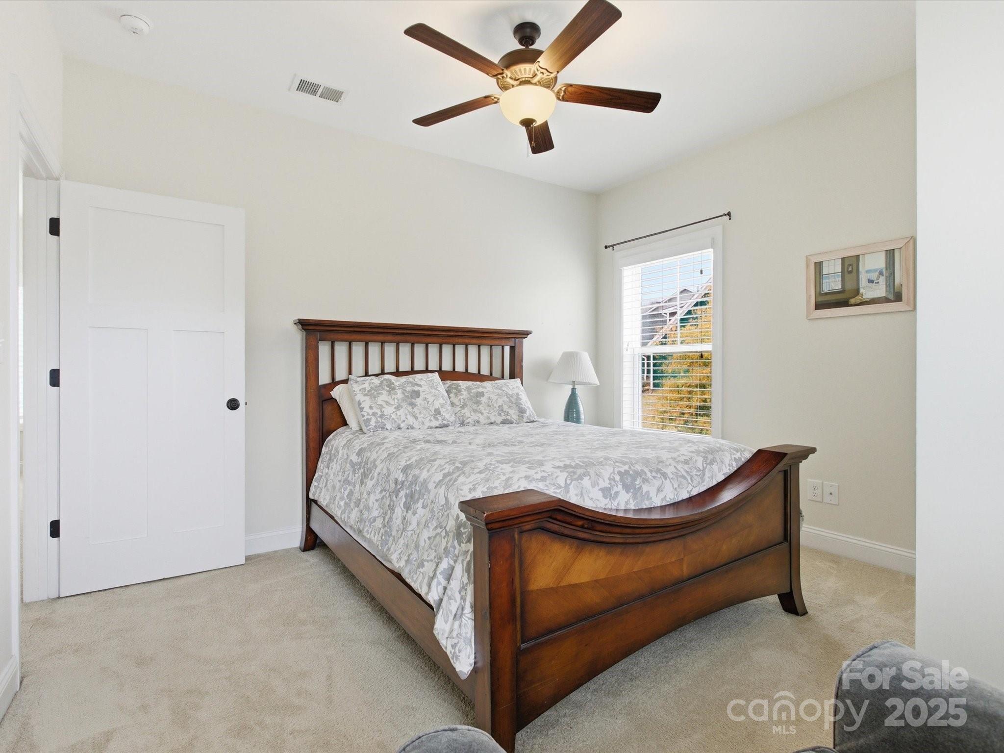 116 Meyers Ridge Road Cramerton, NC 28032 - Photo 29 of 33 a bed sitting in a bedroom next to a window and a chandelier