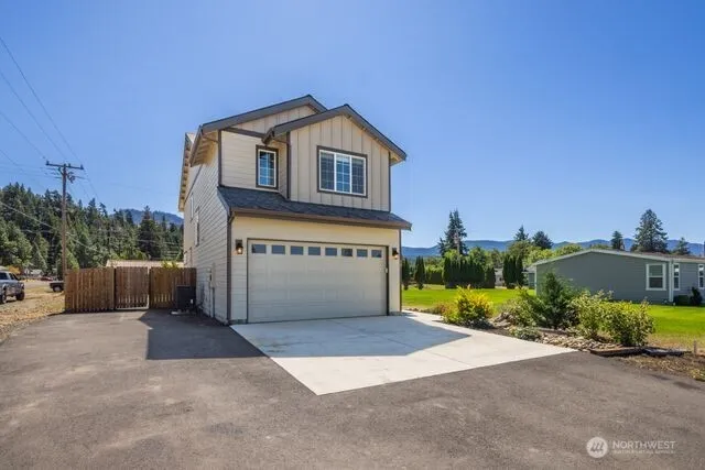a view of a house with a yard and a garage