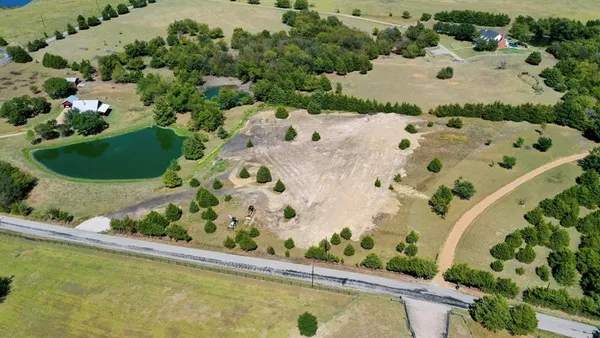 an aerial view of a house with a swimming pool