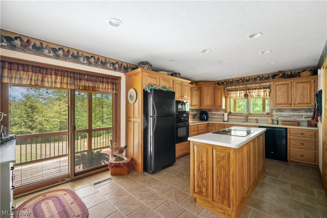 314 Three Bridges Road Palestine, WV 26160 - Photo 22 of 35 another view of kitchen, glass sliding doors leading out onto covered deck
