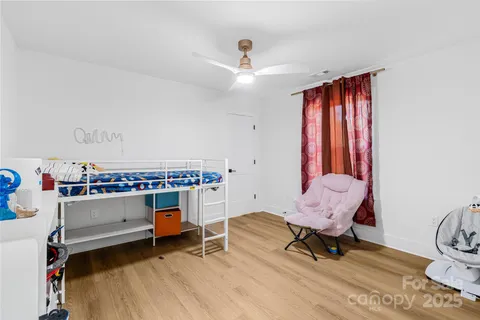 a bed room with a bed and a chandelier