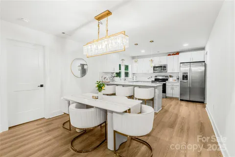 a kitchen with kitchen island a counter top space a sink cabinets and appliances