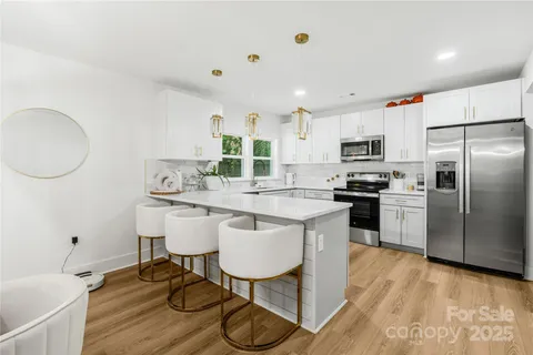 a kitchen with granite countertop cabinets stainless steel appliances and a counter space