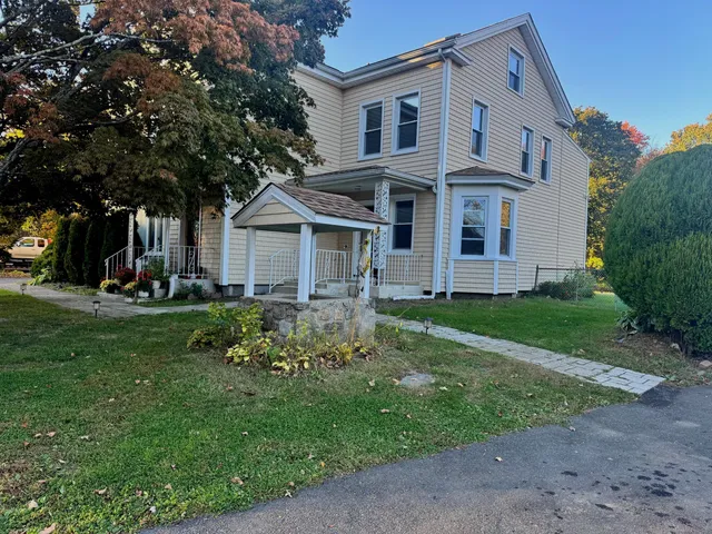 a front view of a house with a yard