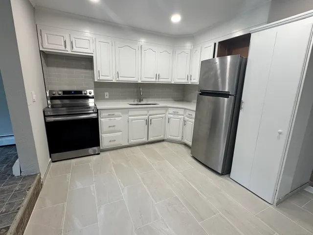 a kitchen with a refrigerator and a sink