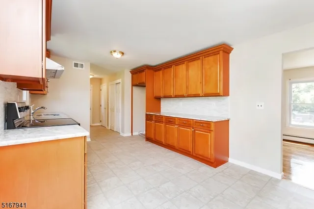 a kitchen with stainless steel appliances granite countertop a sink and a refrigerator