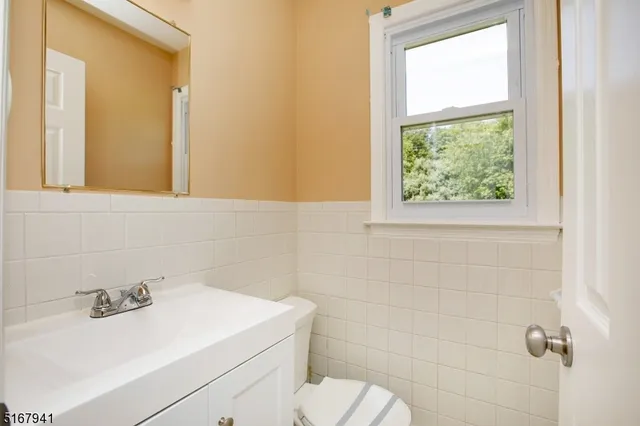 a bathroom with a sink a toilet and a mirror