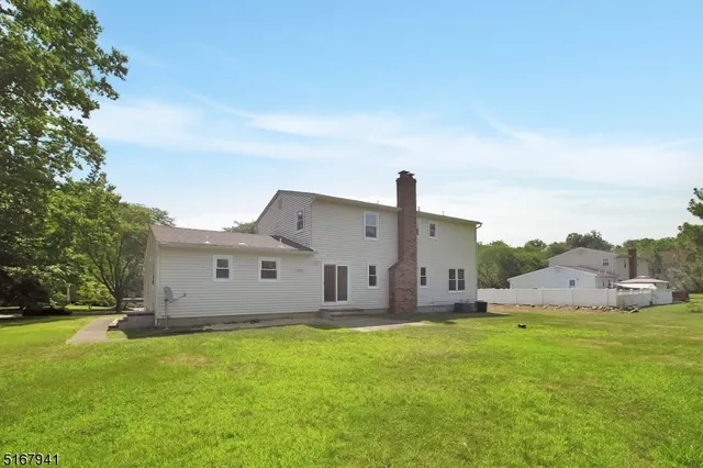 a house view with swimming pool in front of it