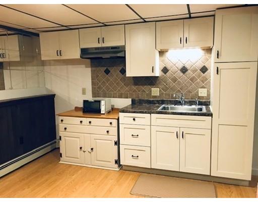 201 Beaman Road Sterling, MA 01564 - Photo 30 of 38 a kitchen with stainless steel appliances granite countertop a sink a stove and white cabinets