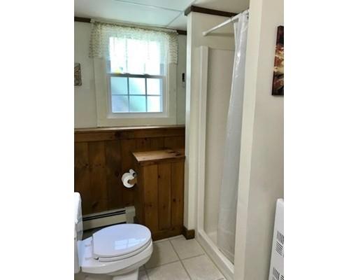 201 Beaman Road Sterling, MA 01564 - Photo 36 of 38 a bathroom with a toilet a window and shower