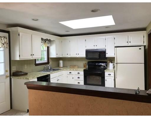 201 Beaman Road Sterling, MA 01564 - Photo 8 of 38 a kitchen with stainless steel appliances granite countertop a refrigerator sink stove and white cabinets
