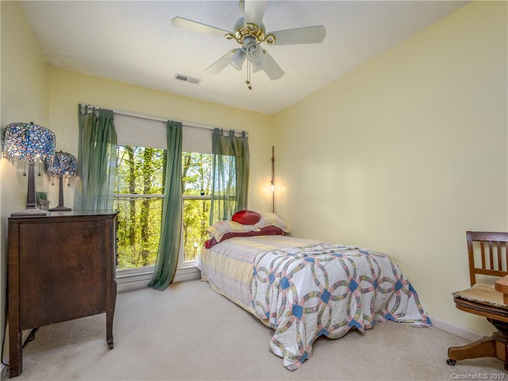 17 Finlay Ridge Road Hendersonville, NC 28739 - Photo 18 of 32 a bedroom with a bed and a chandelier