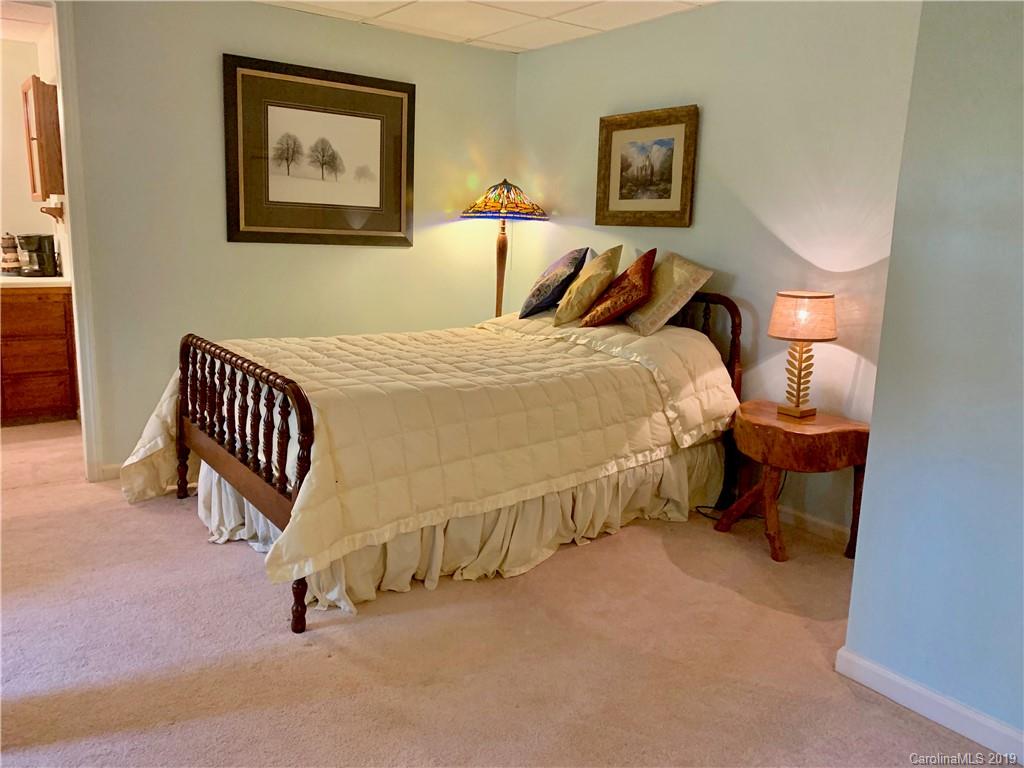 17 Finlay Ridge Road Hendersonville, NC 28739 - Photo 21 of 32 a bed room with a bed and a chair