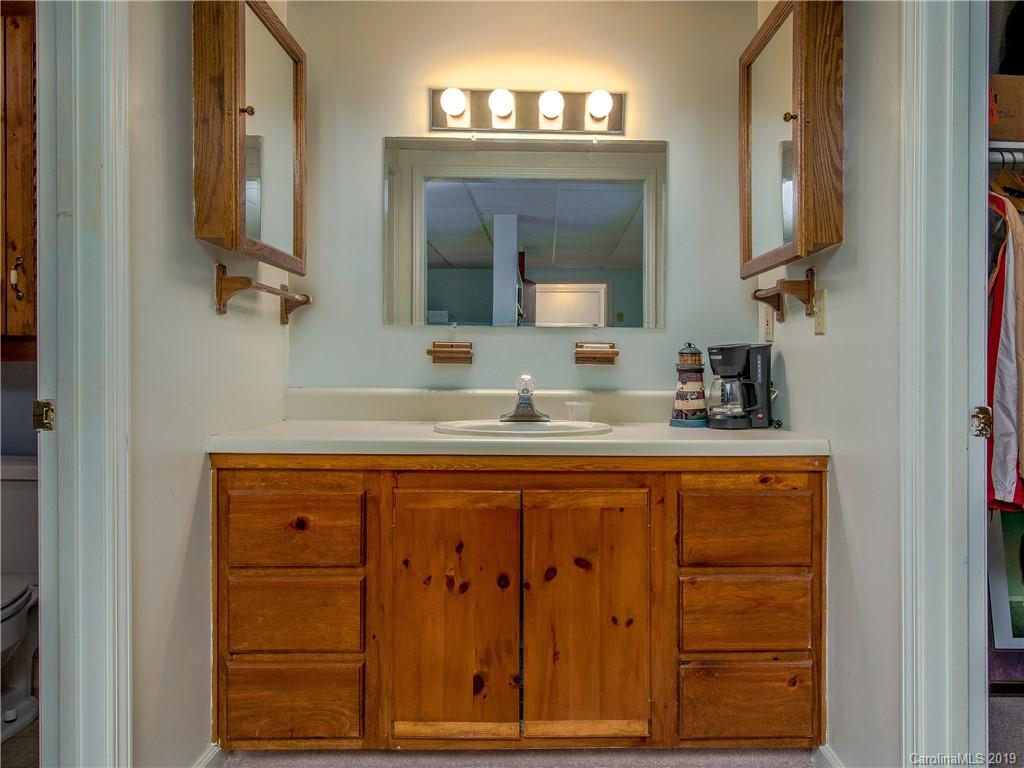 17 Finlay Ridge Road Hendersonville, NC 28739 - Photo 22 of 32 a bathroom with a sink vanity and mirror