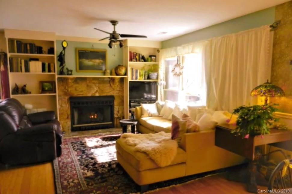 17 Finlay Ridge Road Hendersonville, NC 28739 - Photo 8 of 32 a living room with furniture large window and fireplace