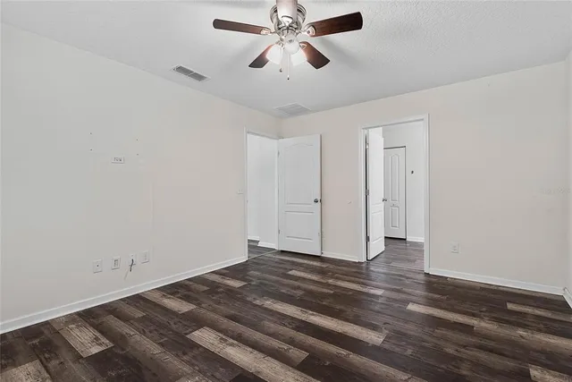 a view of a chandelier fan and wooden floor