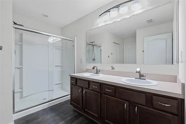 a bathroom with a double vanity sink and mirror