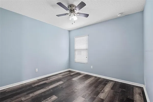 a view of a room with a window and a ceiling fan